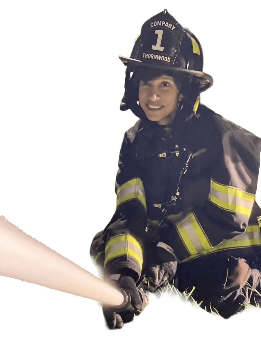 Margaret Cunzio spraying nozzle at the fire department
